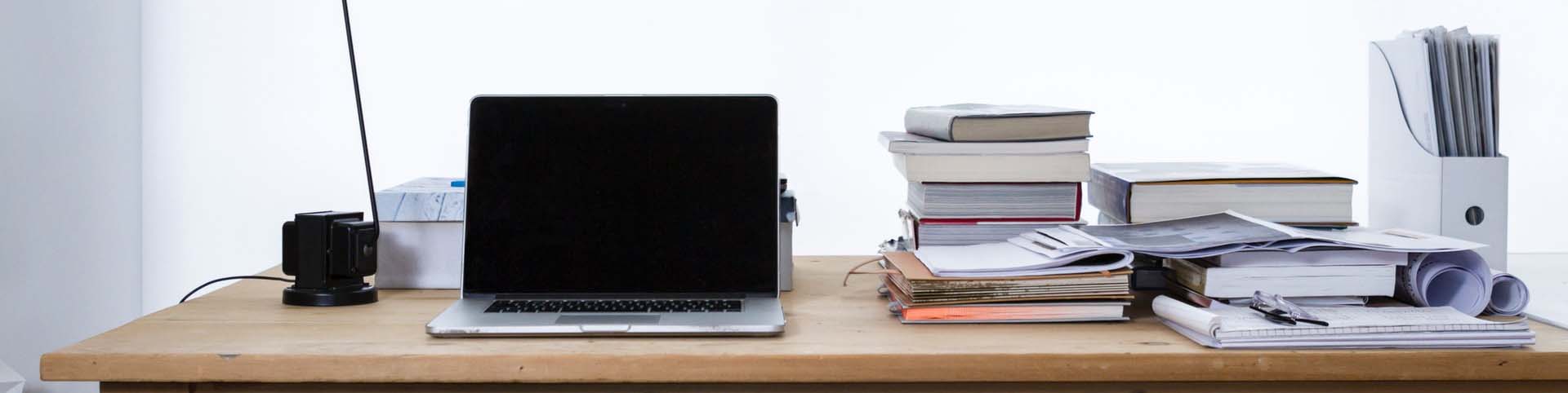 bg-desktop-view-with-books-papers-and-laptop