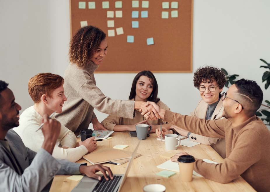 img-young-employees-meeting-and-shaking-hands